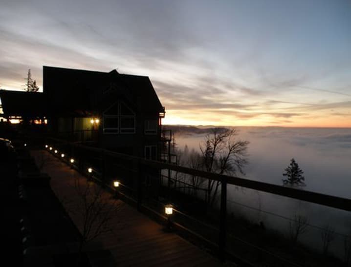 a silhouette of the B&B against the fog-filled valley