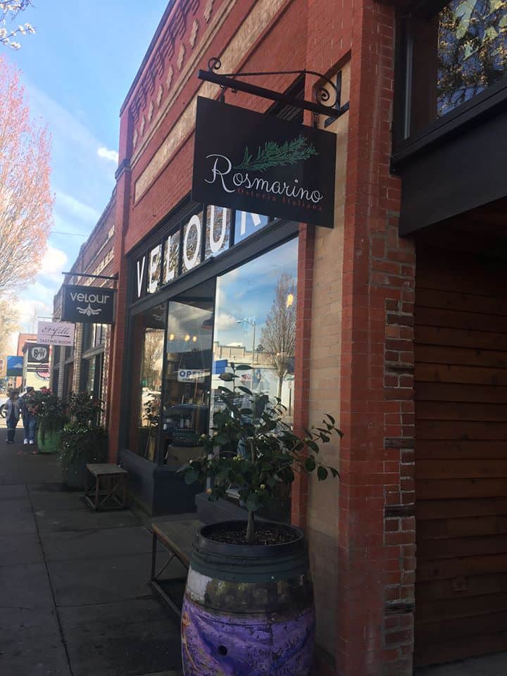 Storefront of brick building with sign of Rosmarino restaurant