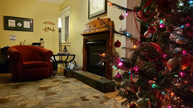 living room with chair, fireplace and Christmas tree