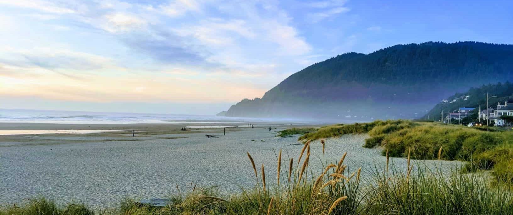 an Oregon sandy beach with a headland in the distance