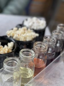 small carafes of wine for tasting and flavored popcorn in cups