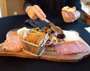 a cheese and charcuterie board to pair with willamette valley wines at Hawks View Winery. Olives, crackers and nuts accompany