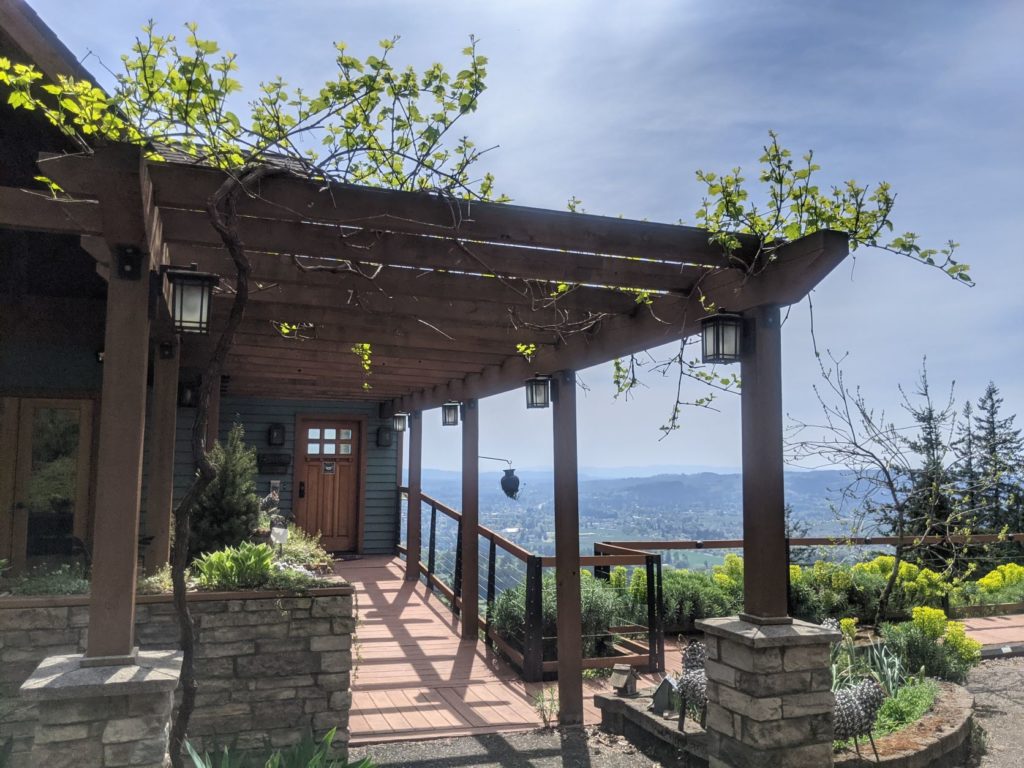 A walkway leading up to the front door of a house with panoramic views of the willamette valley