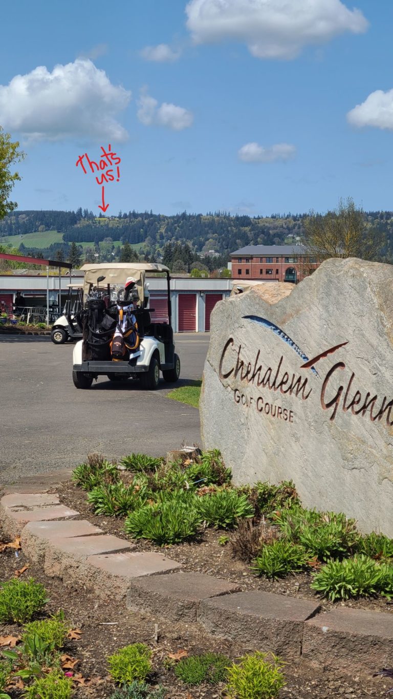 Large rock acting as a sign with Chehalem Glenn Golf Course etched on it. Chehalem Ridge B&B is noted by an arrow drawn at the top of the picture in the distance