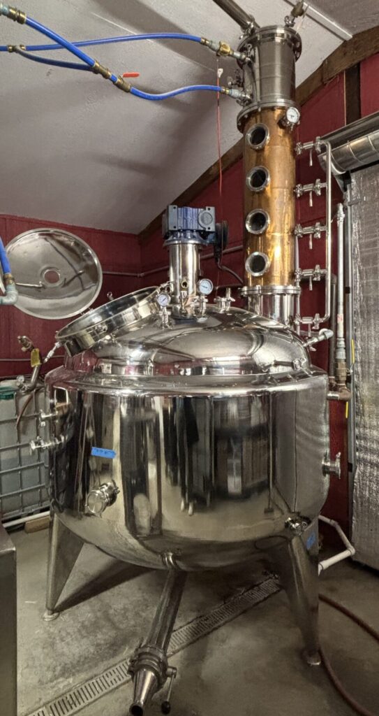 A stainless steel still with copper pipes used for distilling alcohol at Killdeer Distillery