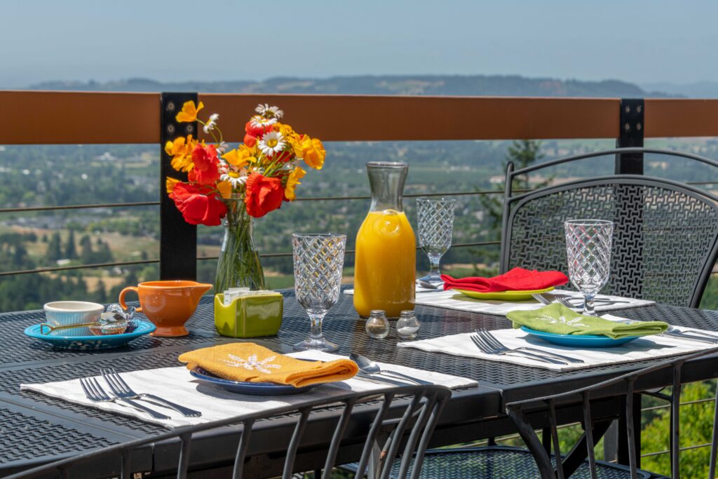 Outdoor table set for breakfast with flowers